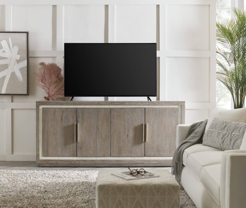 a beige entertainment center and media storage with a flat screen TV