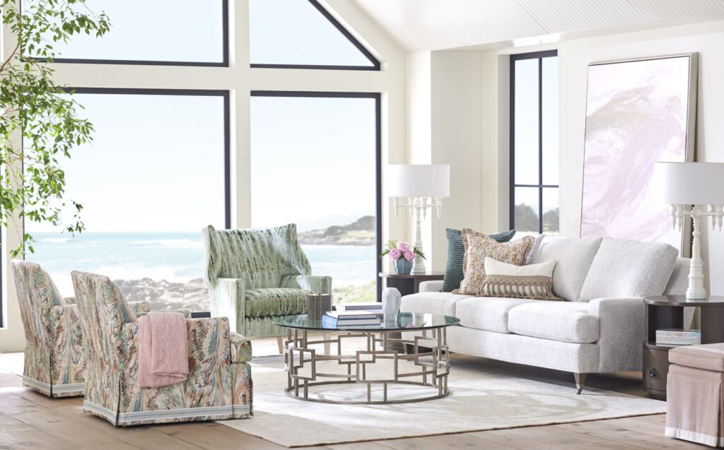 a living room with couches and coffee table facing near windows